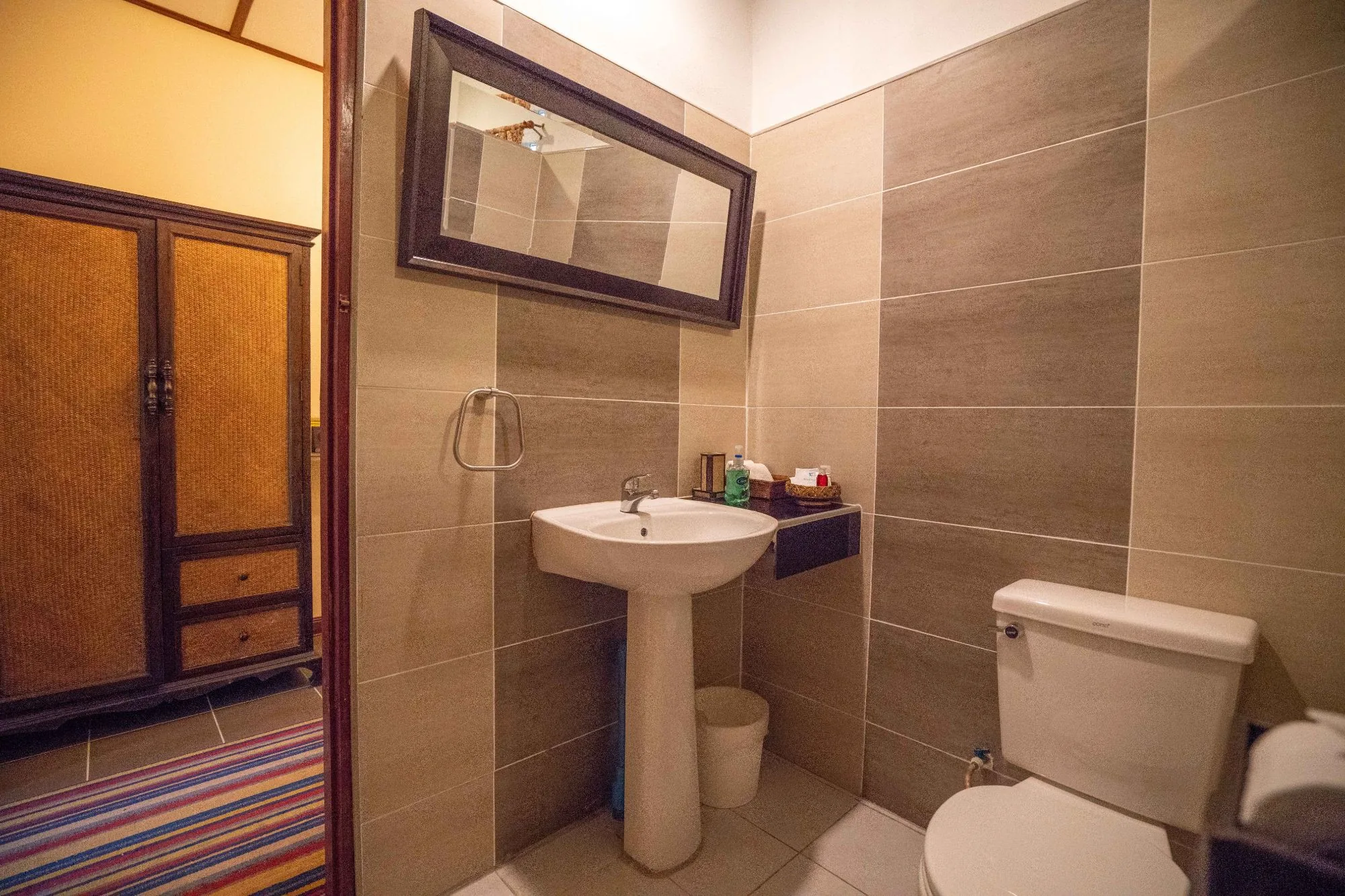 Air Nest bathroom with basin, mirror and teak wardrobe