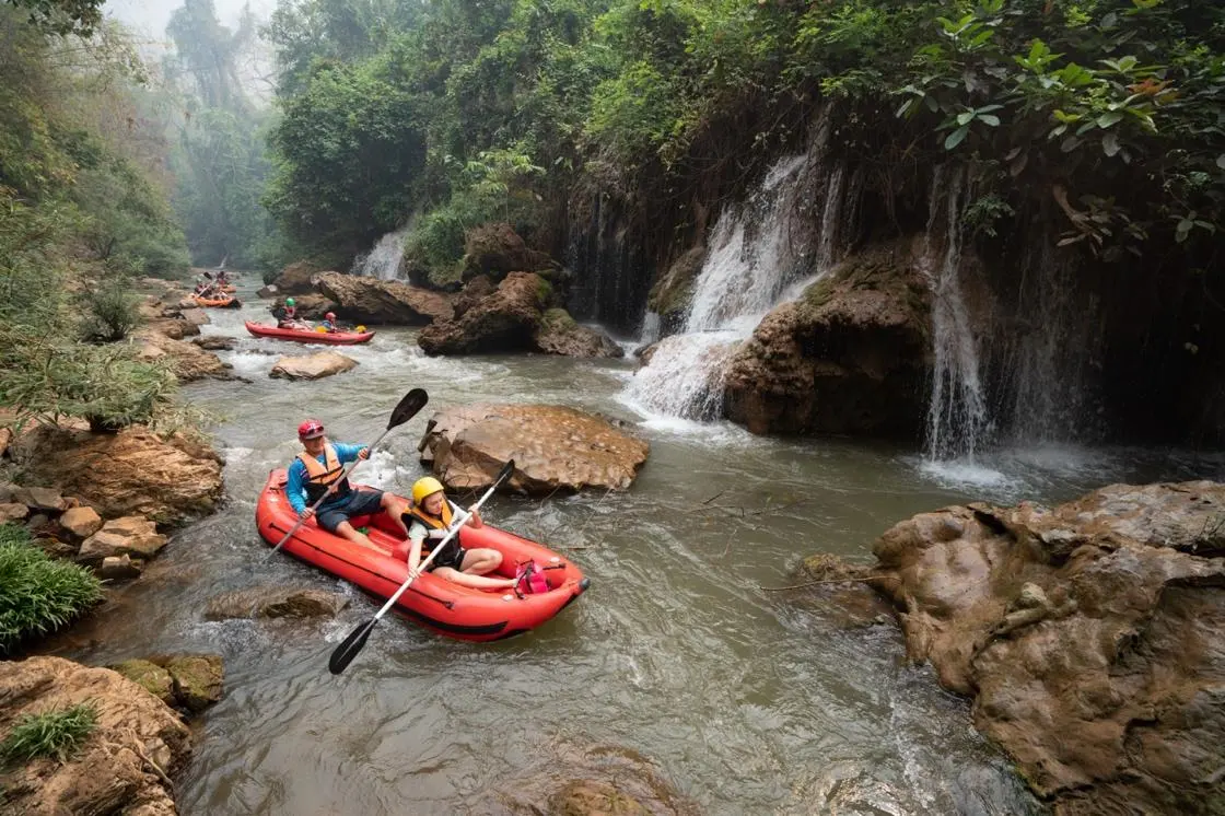 Kayaking past waterfalls on the Khong River