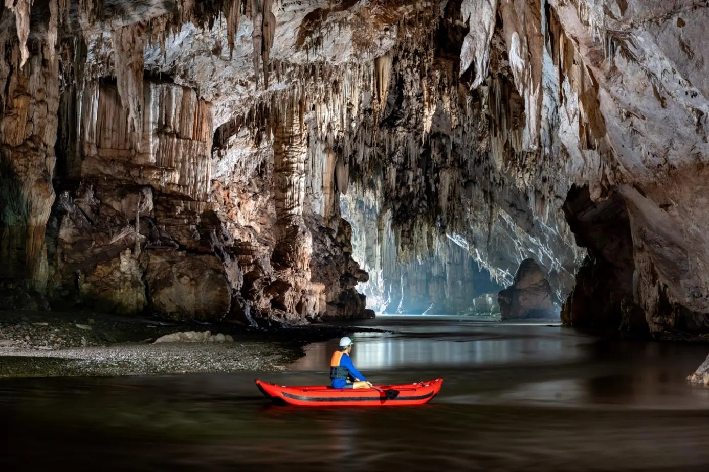 Kayak beneath cave formations on the Lang River